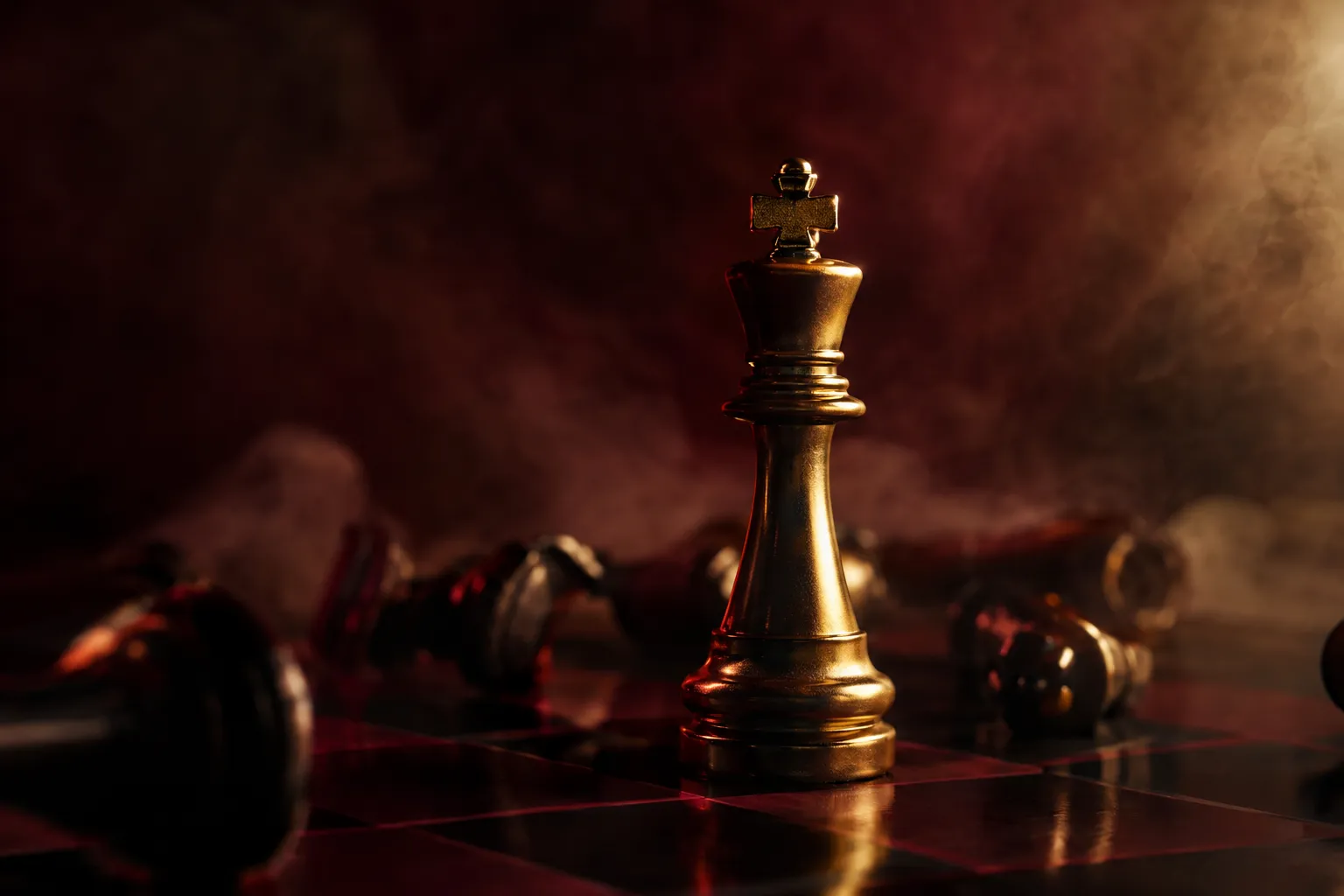 A gold king chess piece standing alone on a burgundy board among toppled pieces